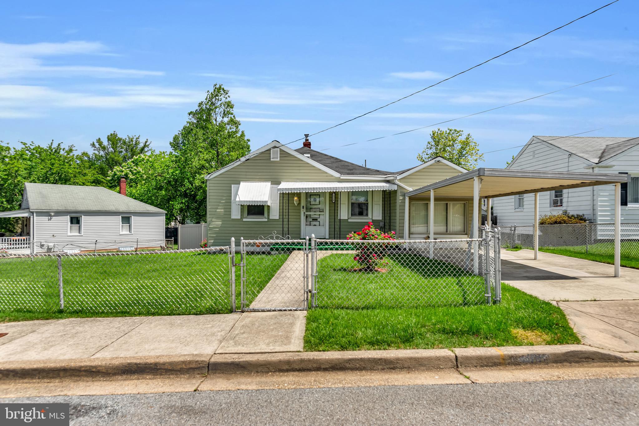 a front view of a house with a yard table and chairs