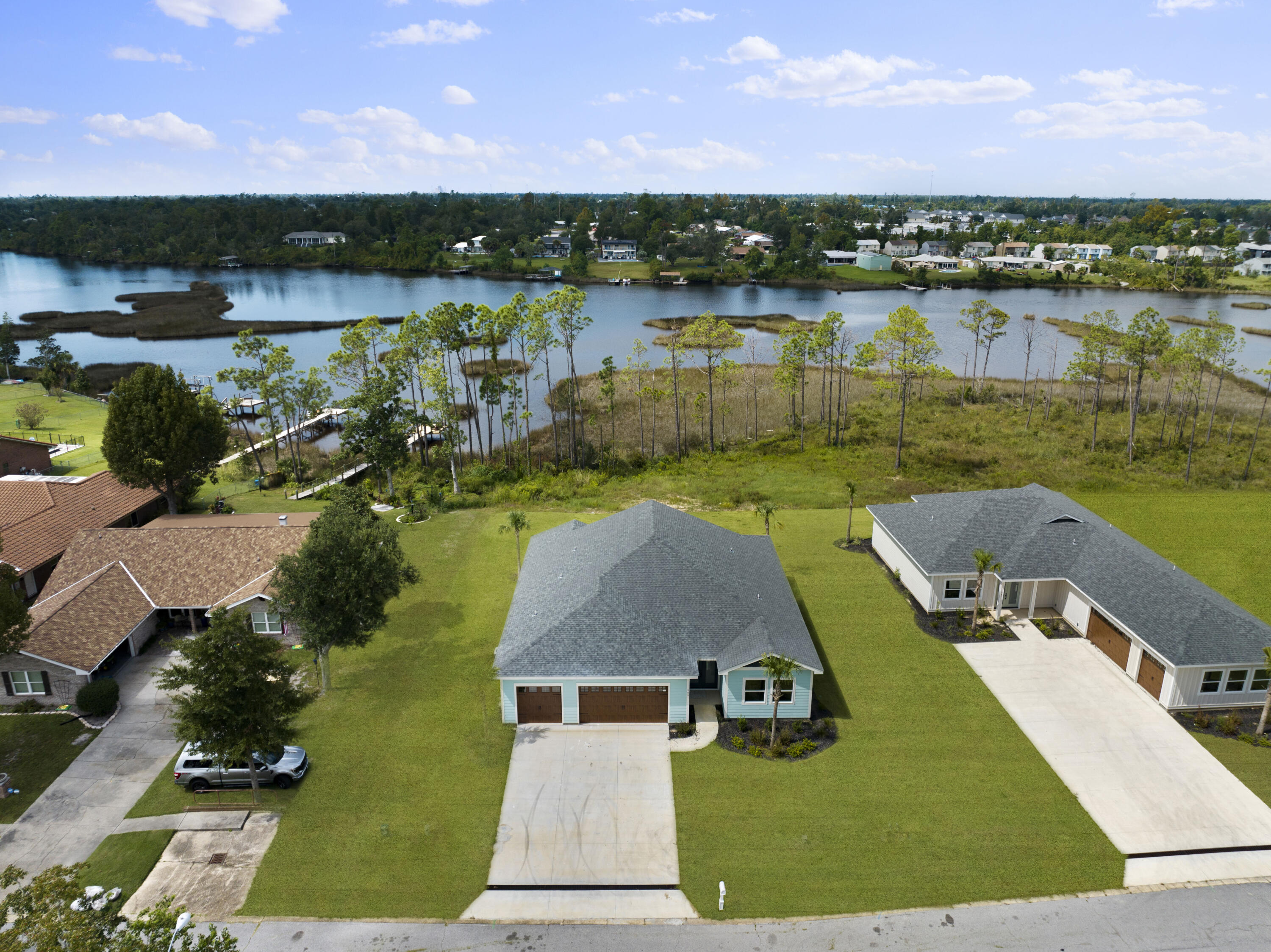 a view of a lake with a yard and a patio