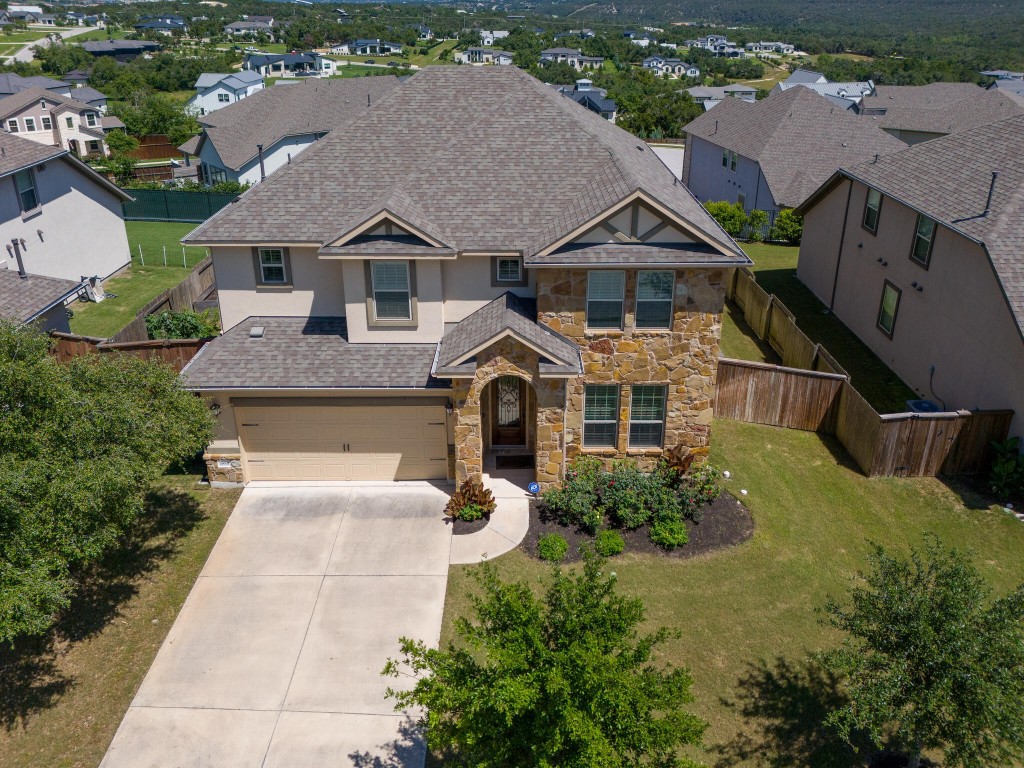 Aerial View of the front of this home with lovely landscaping in the community of Bella Colinas