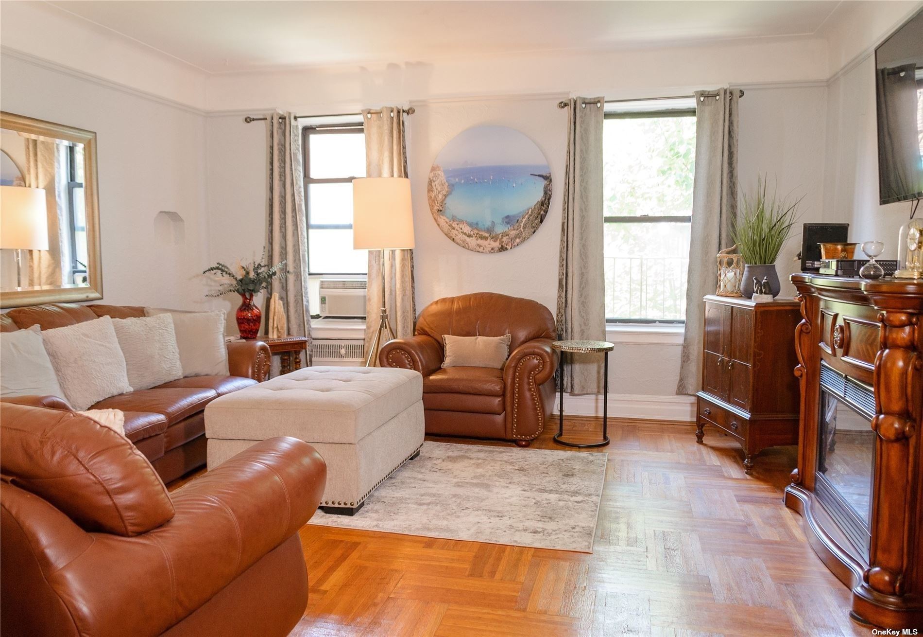 a living room with furniture fireplace and a large window