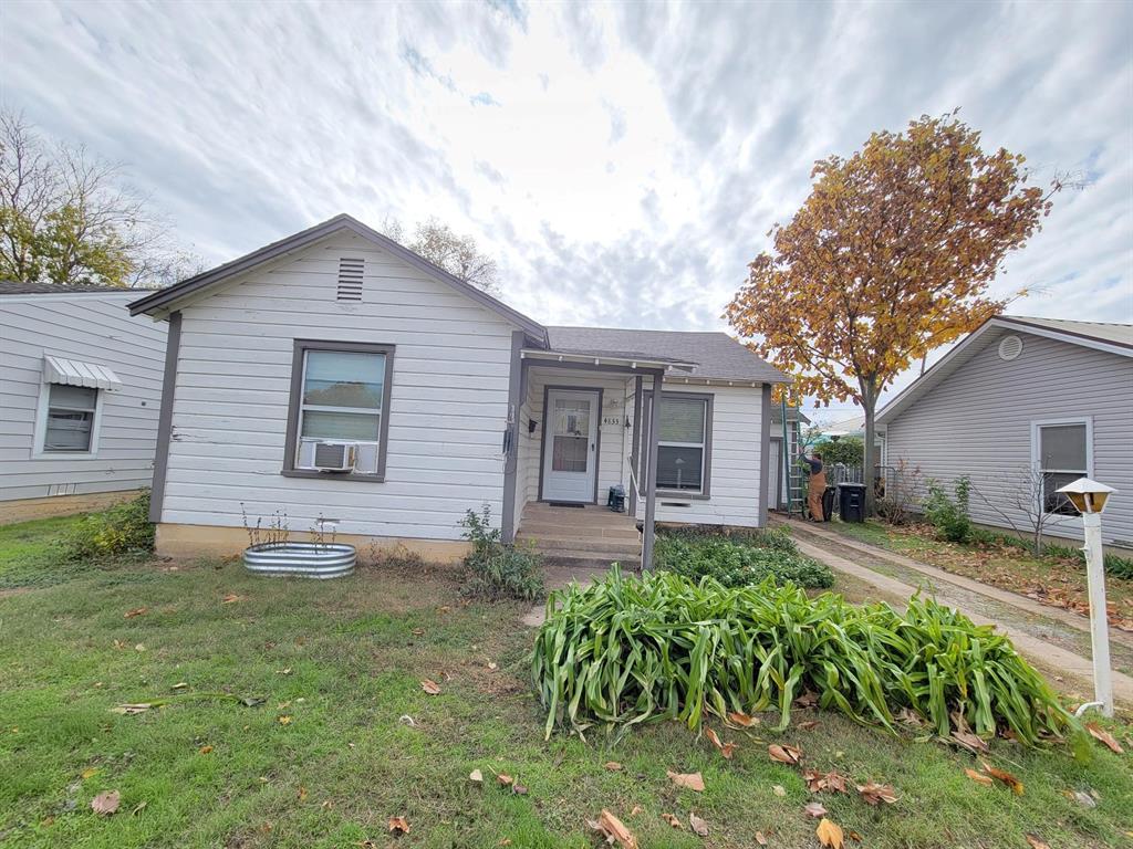 a front view of house with yard and outdoor seating