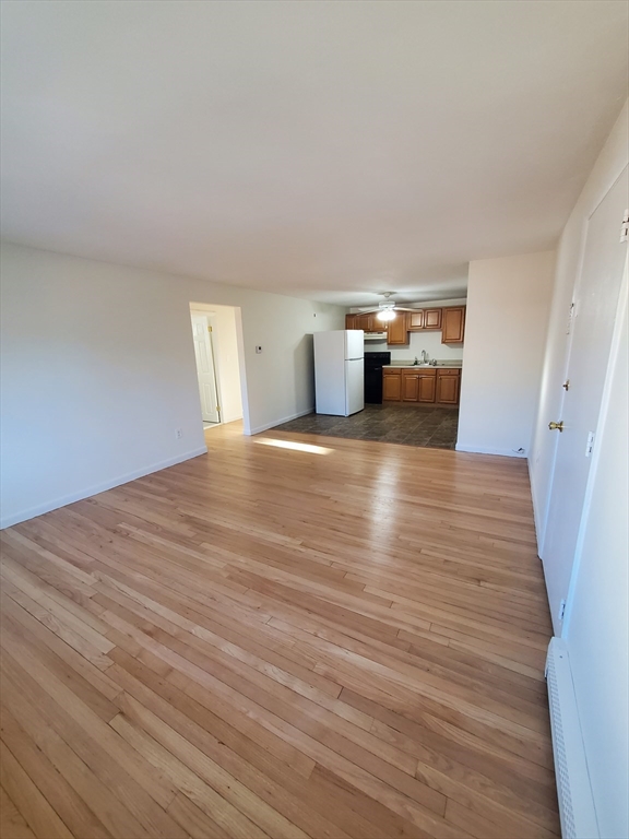 a view of a room with wooden floor