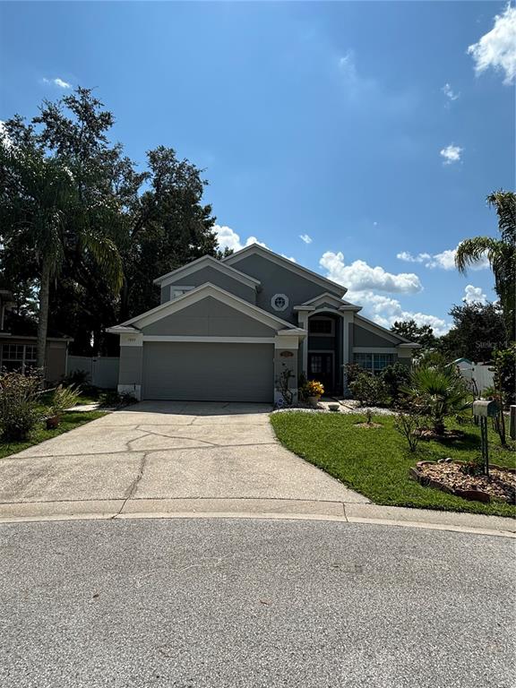 a front view of a house with a yard and garage