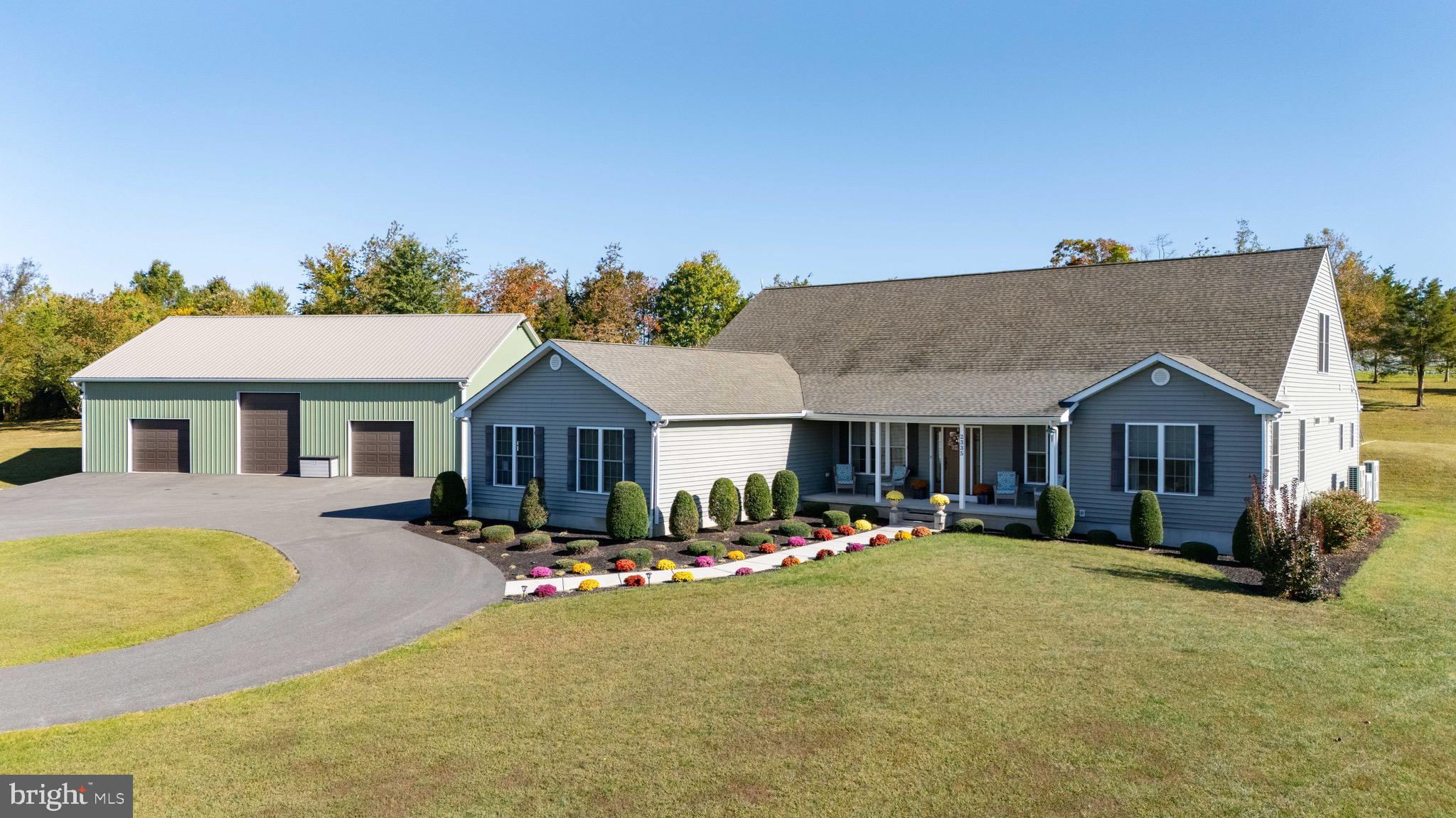 a front view of house with yard and trees in the background