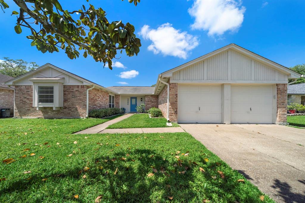 a view of a house with a yard and garage