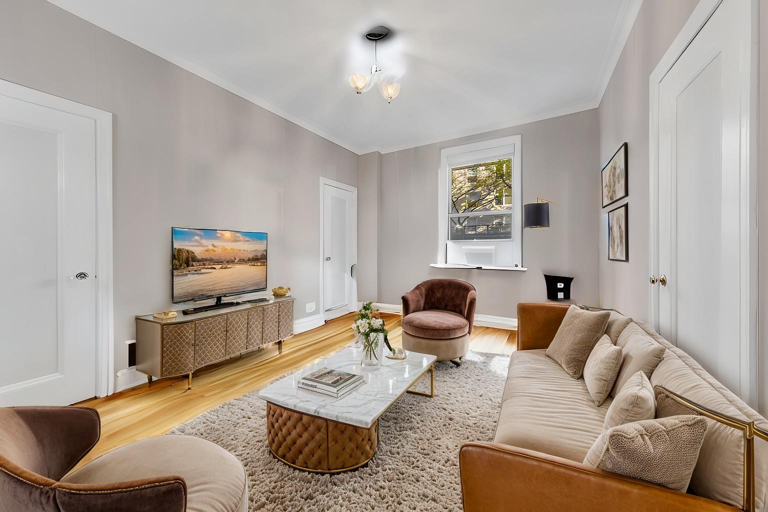 a living room with furniture and a flat screen tv