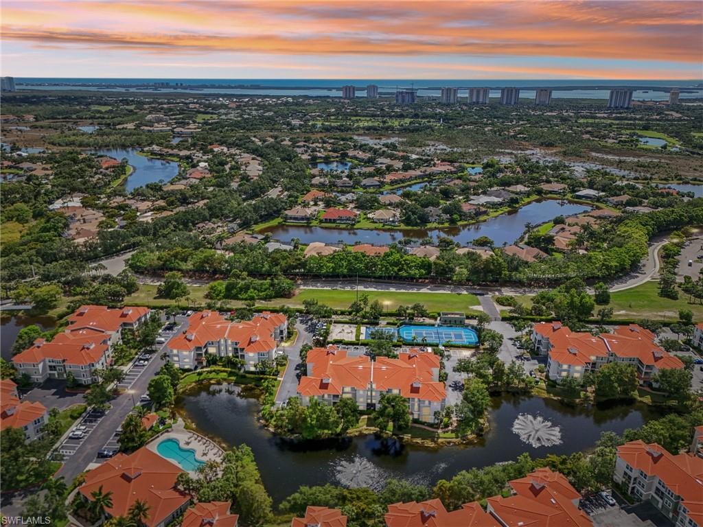 Aerial view at dusk featuring a water view