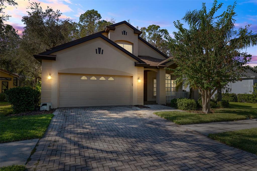 a front view of a house with a yard and garage