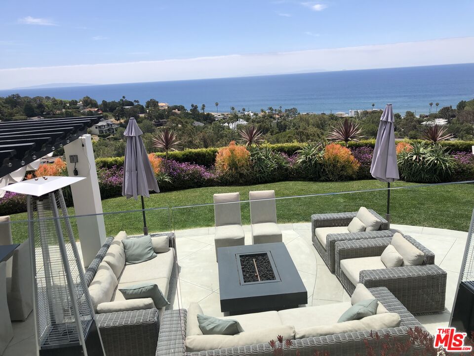 a view of a terrace with couches and city view