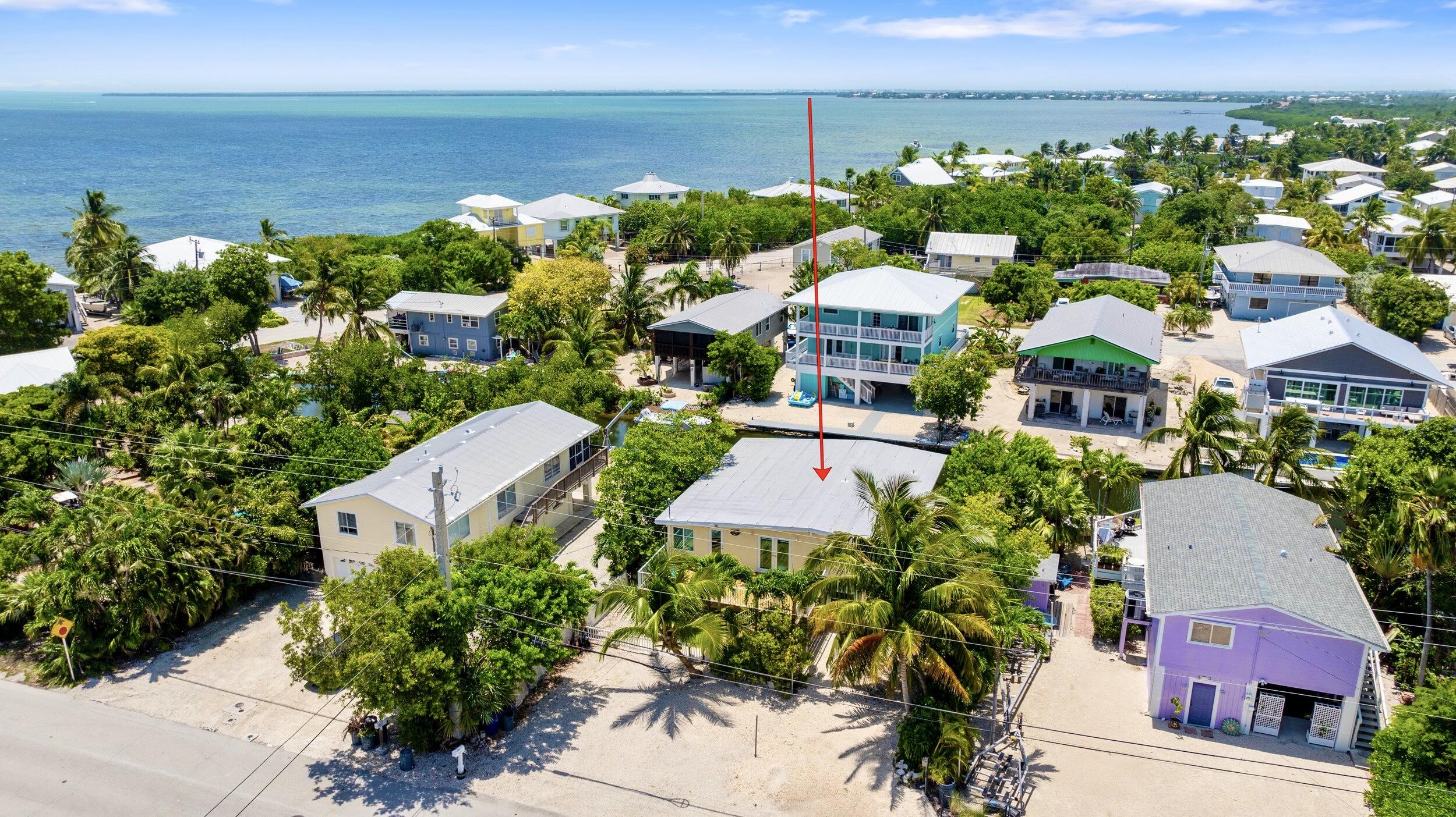 an aerial view of multiple houses with yard