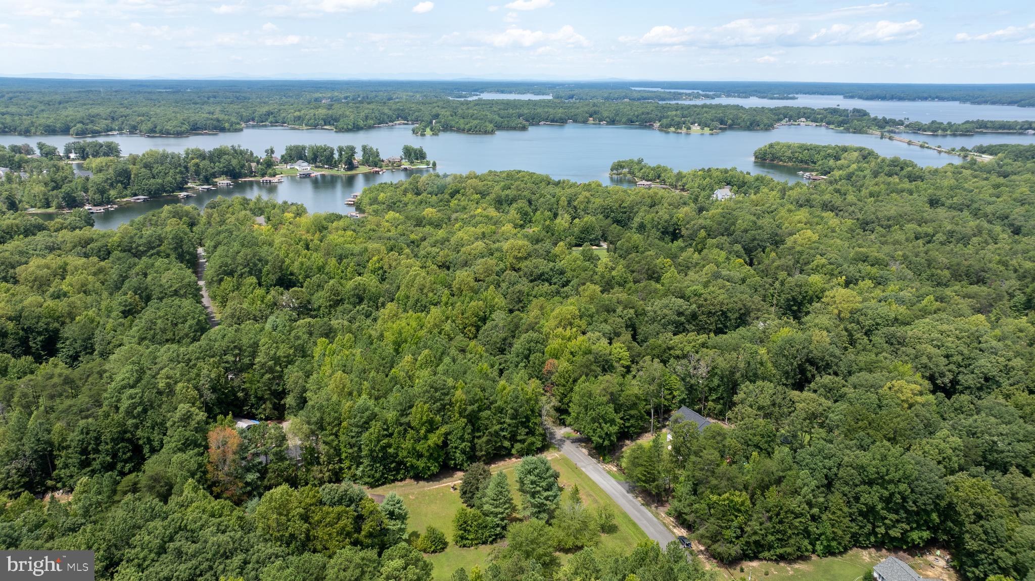 view of a lake with houses in back