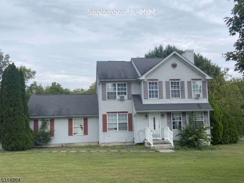 a front view of a house with a yard and a garage