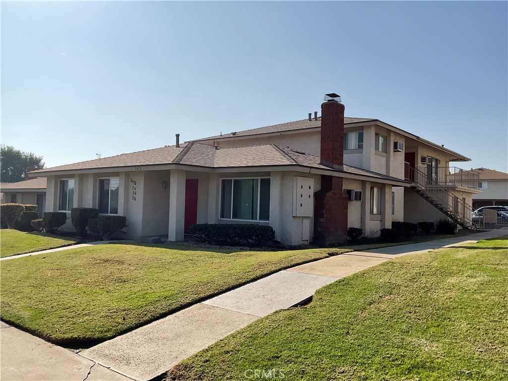 a front view of a house with yard and porch