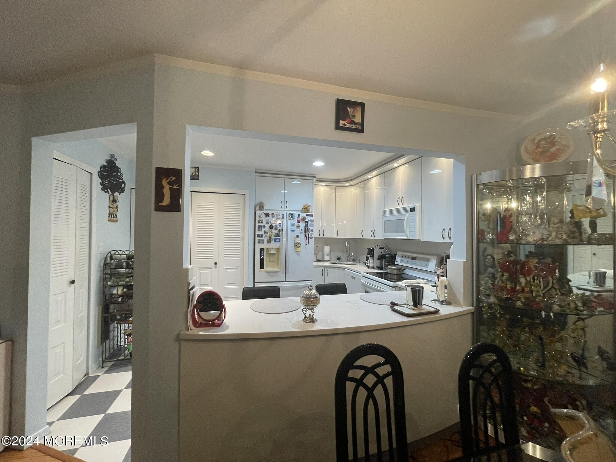 a kitchen with a refrigerator and a sink