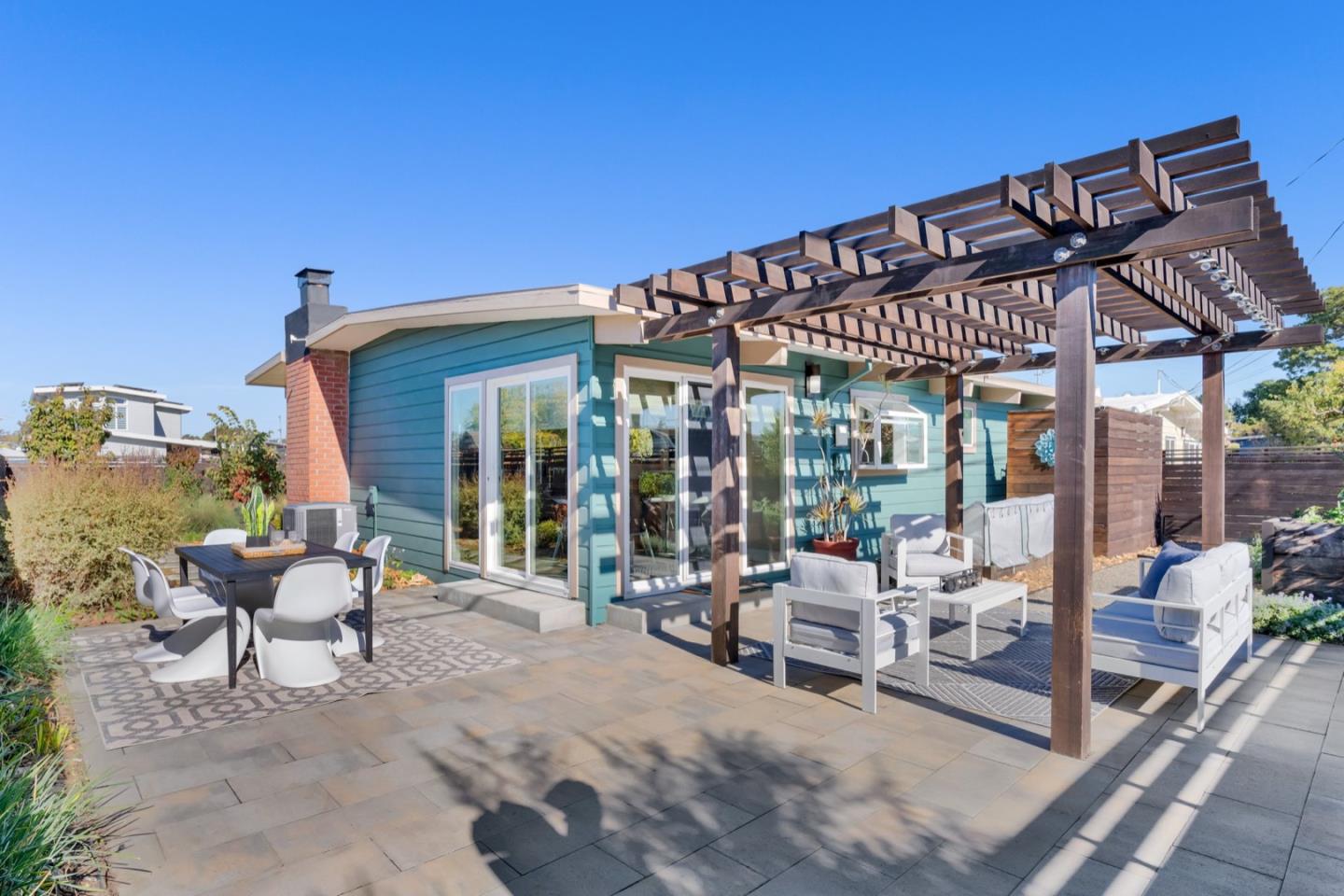 a patio with glass top table and chairs