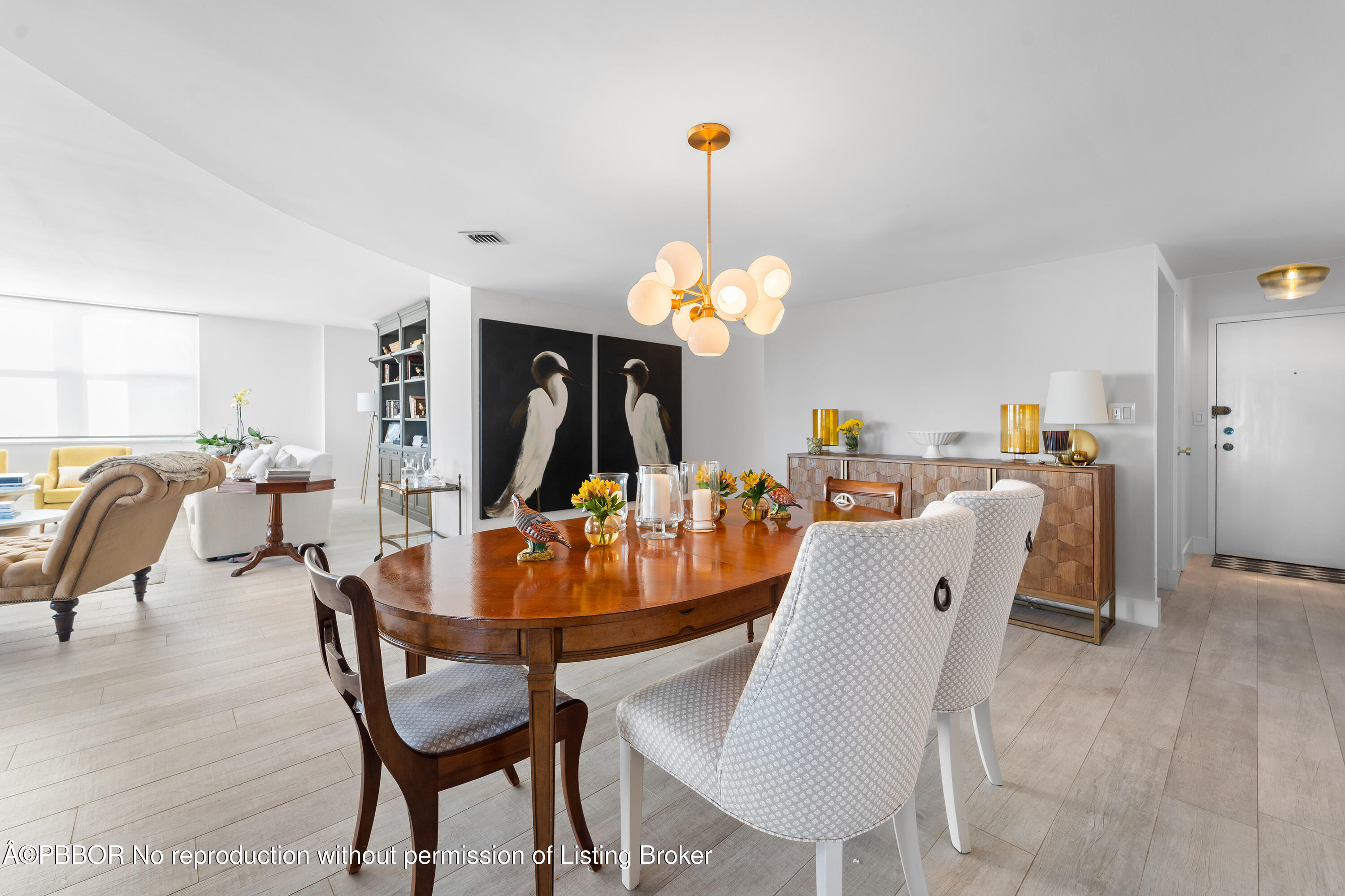 a dining room filled chandelier and wooden floor