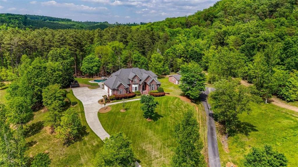 a aerial view of a house with a yard basket ball court and outdoor seating