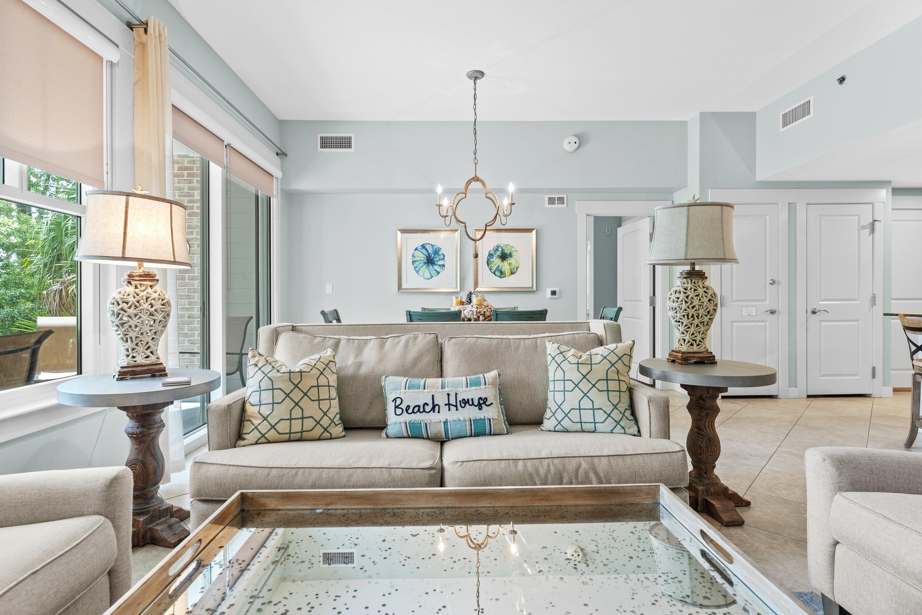 a living room with furniture large window and wall