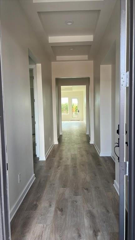 a view of a hallway with wooden shelves