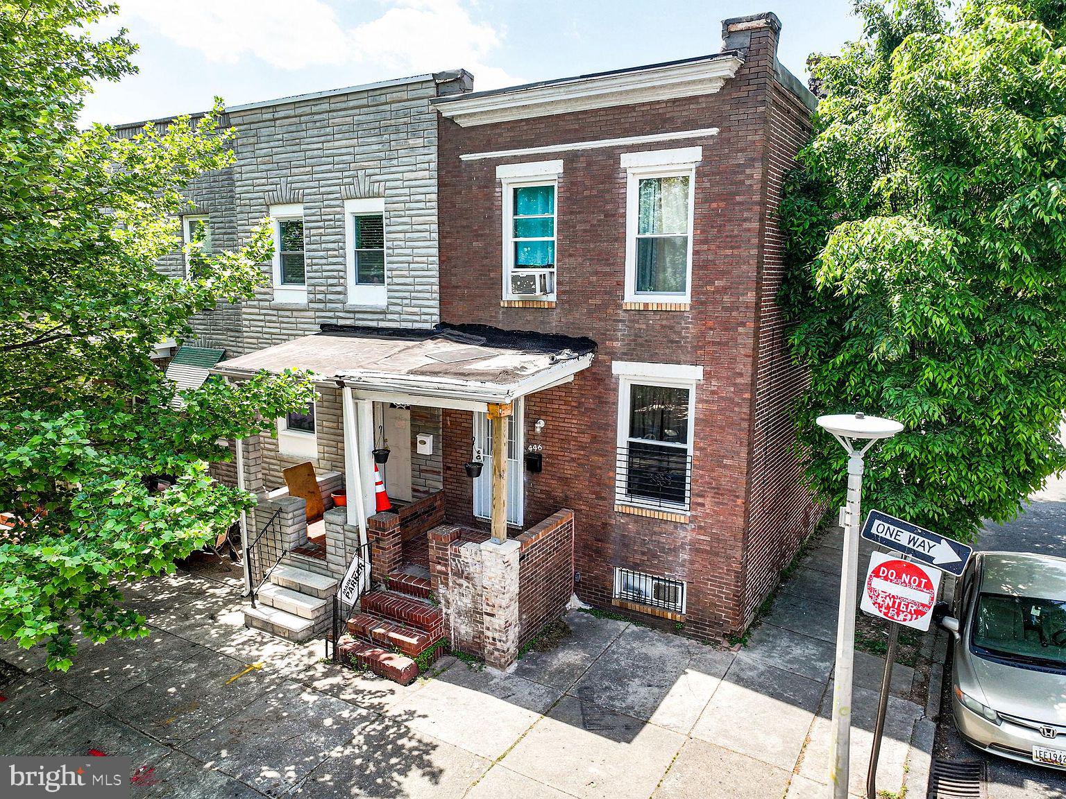 a view of a house with a patio and a yard