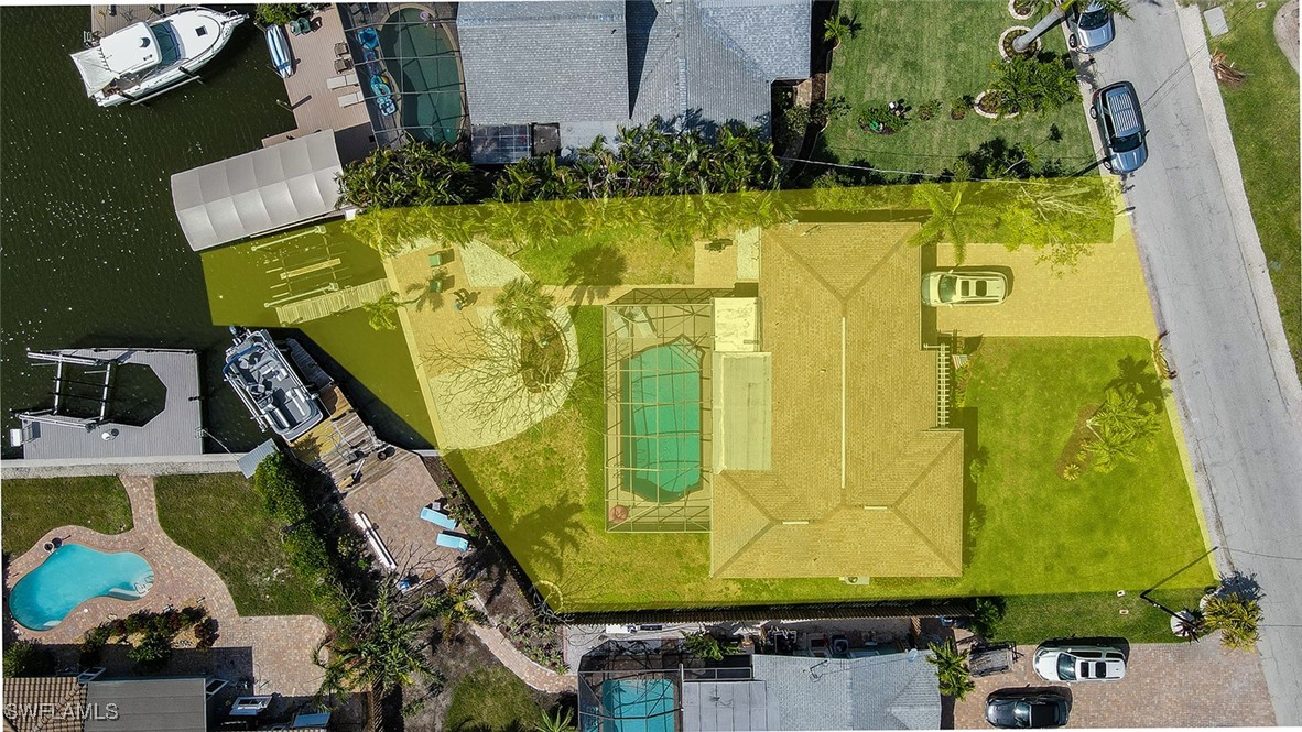 an aerial view of a residential house with swimming pool