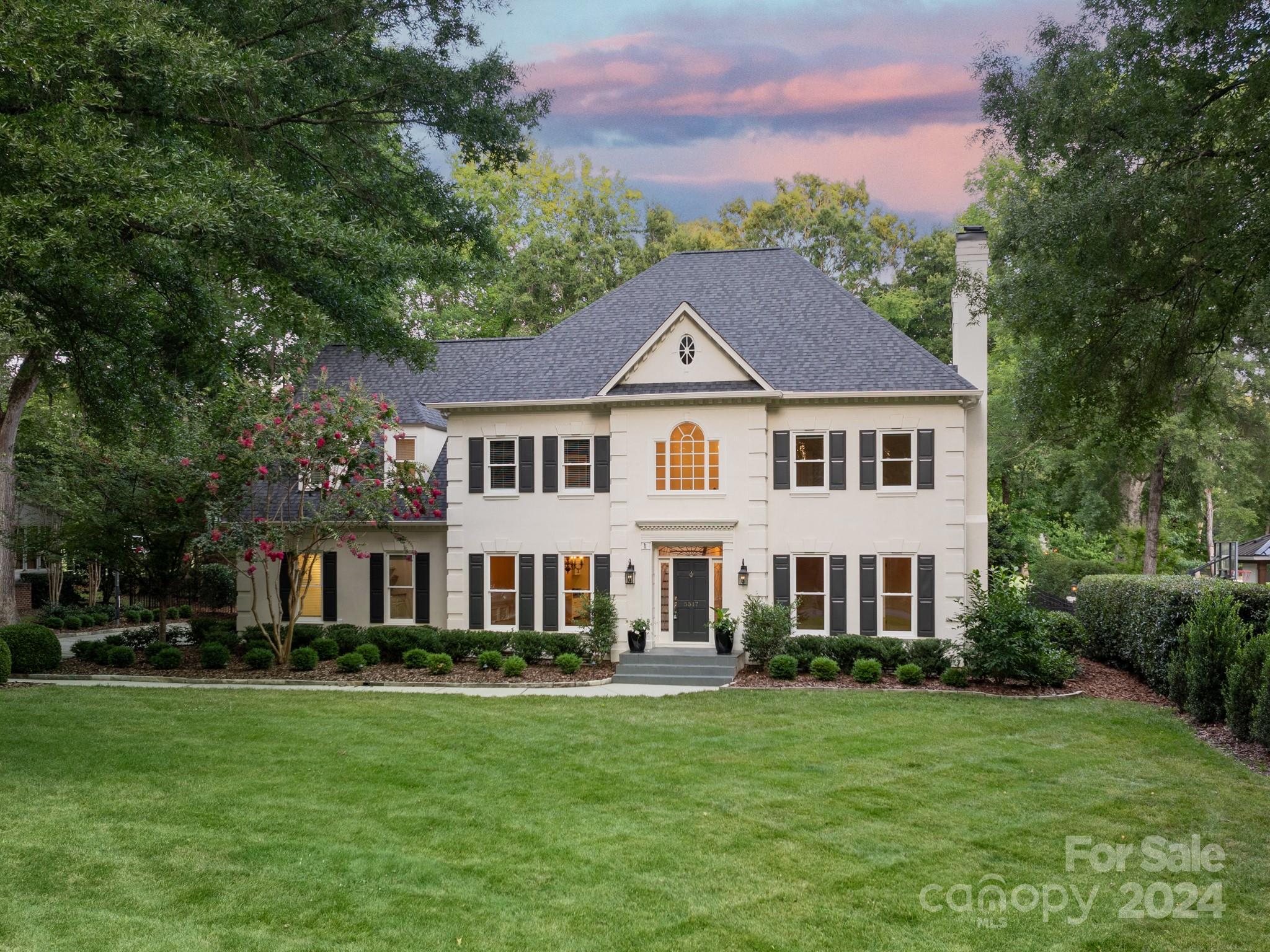 a front view of a house with a garden