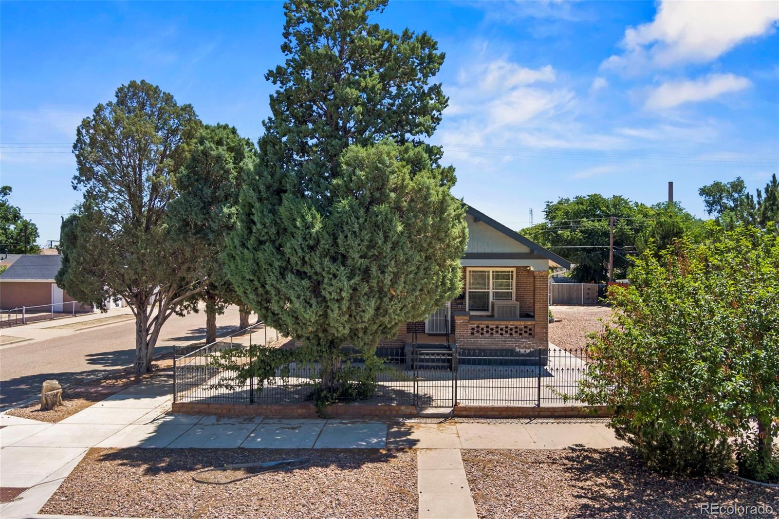 a view of a house with a tree in the background