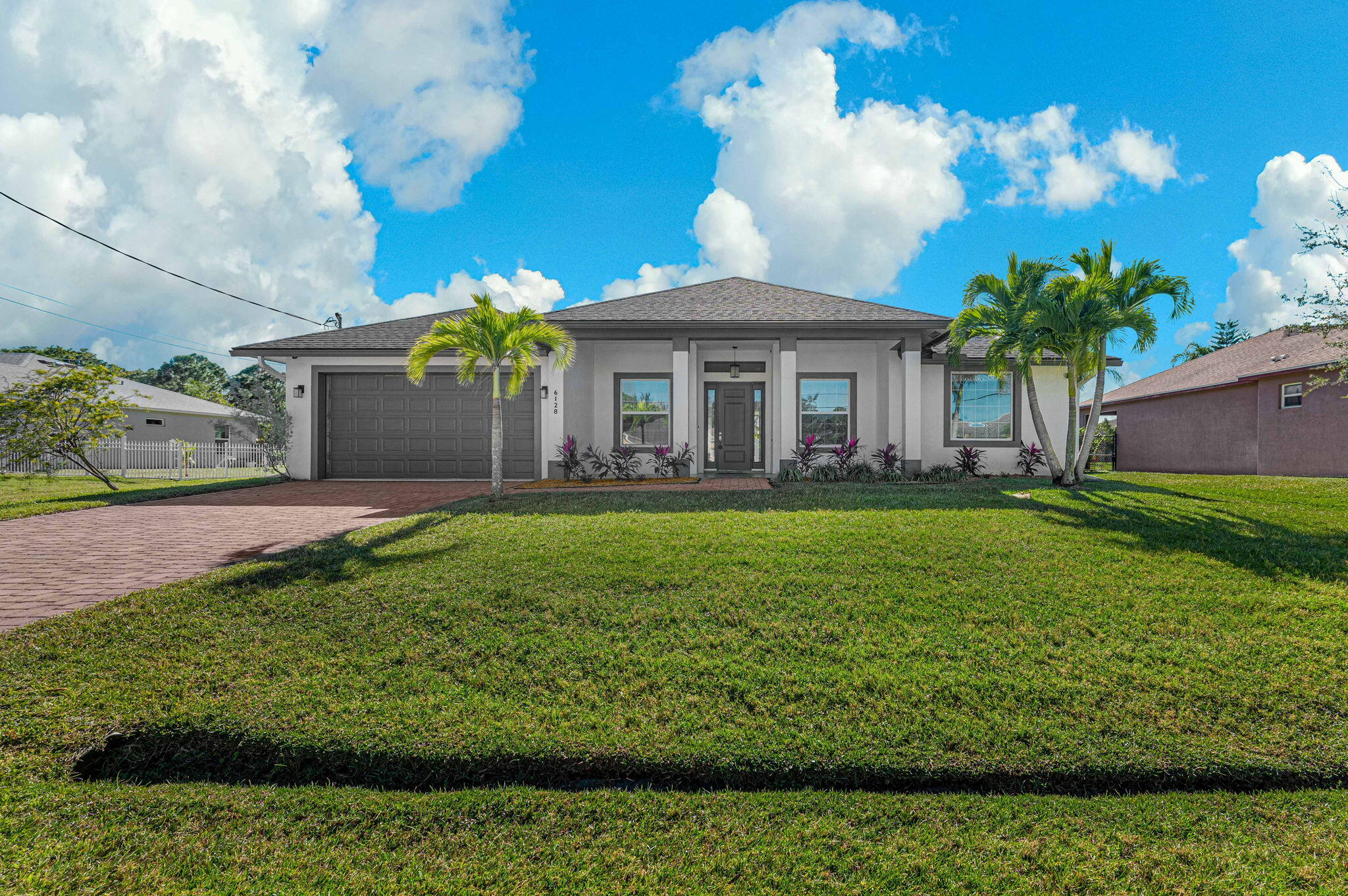 a front view of a house with a garden