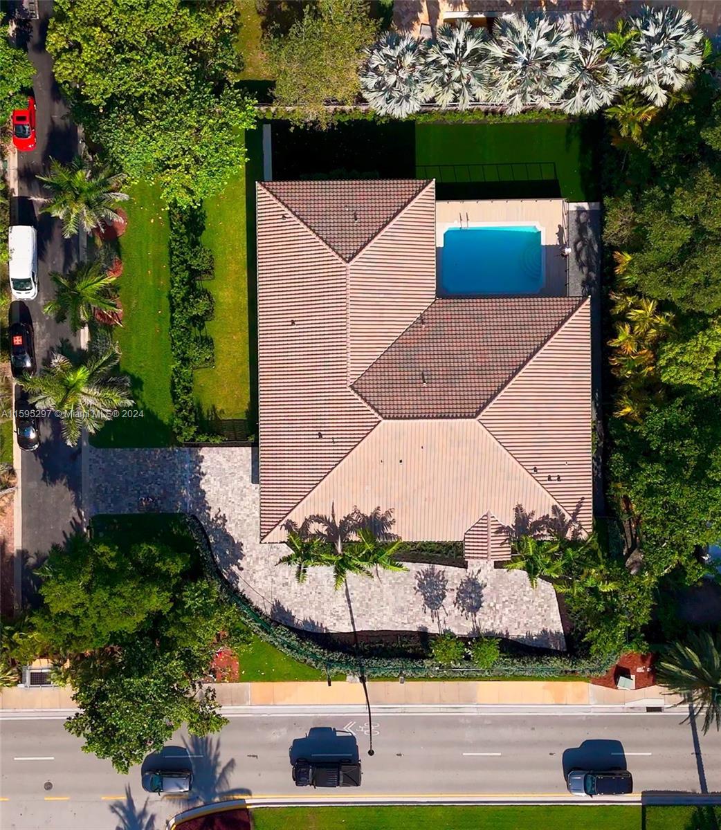 an aerial view of a house with a yard