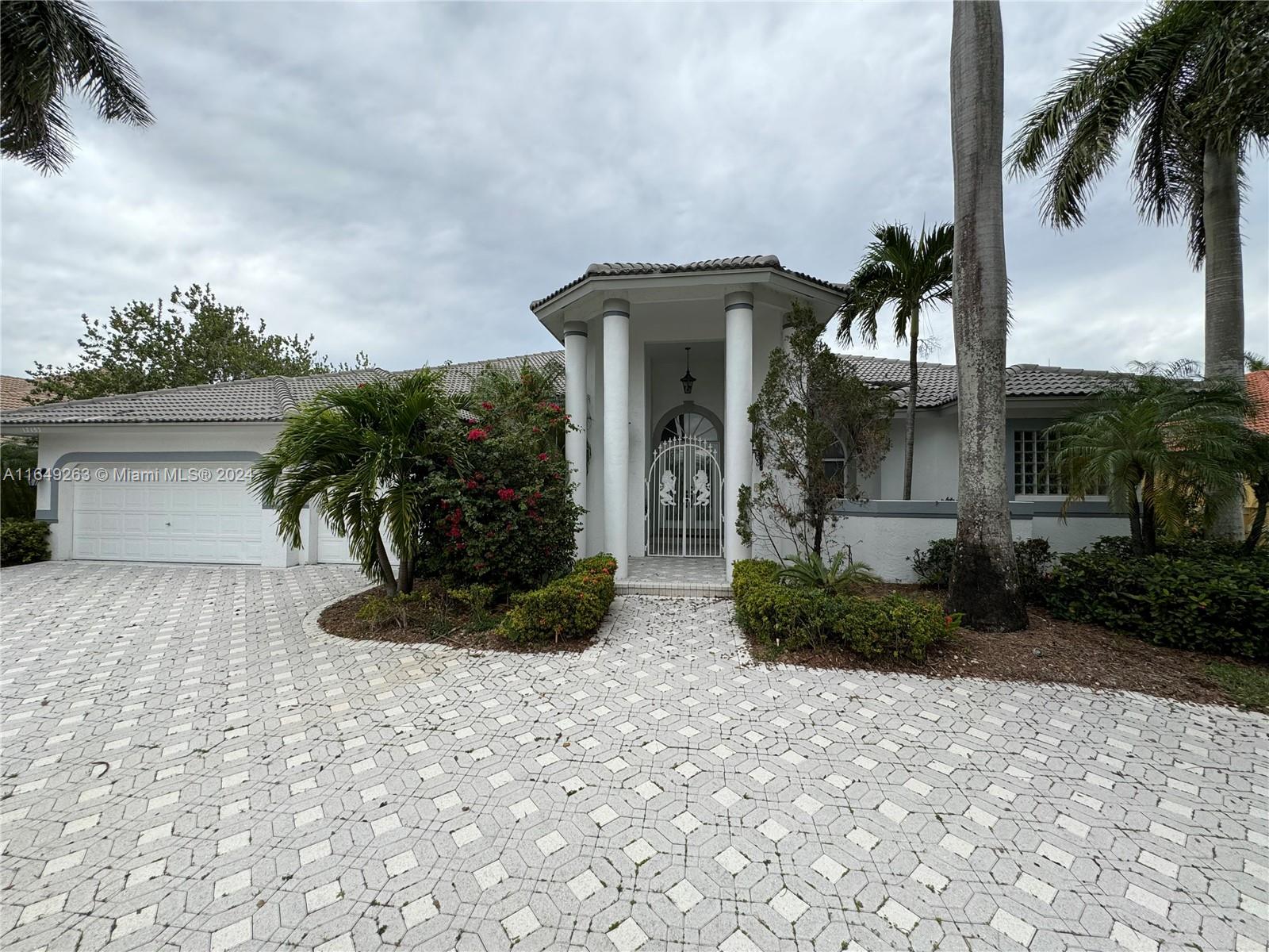 a front view of a house with garden