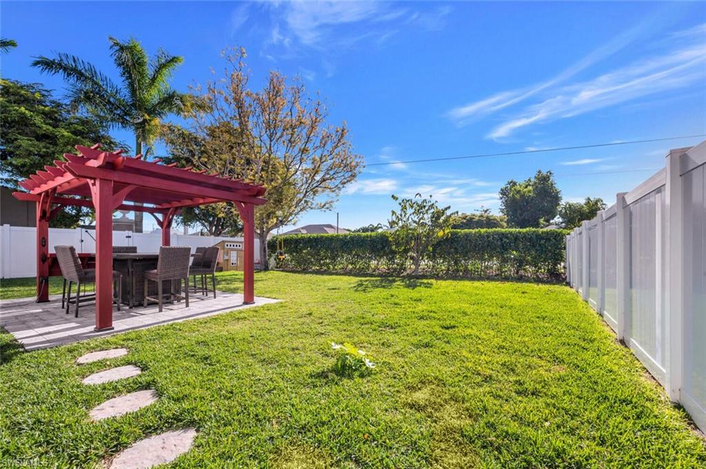 a view of a chairs and table in backyard