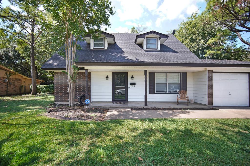 a view of a house with a yard and plants