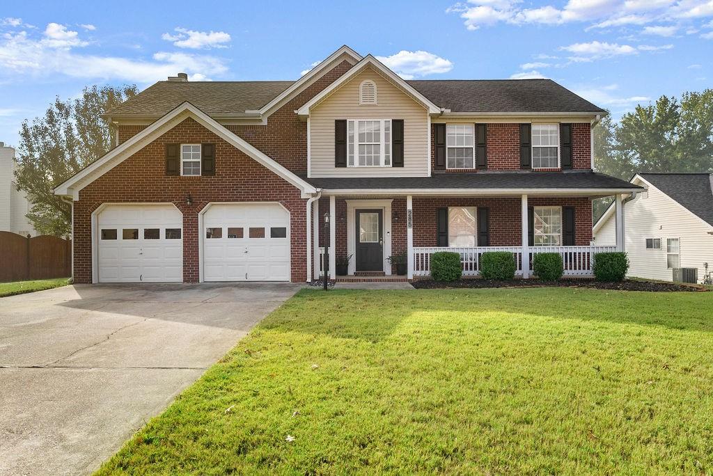 a front view of a house with a yard and garage