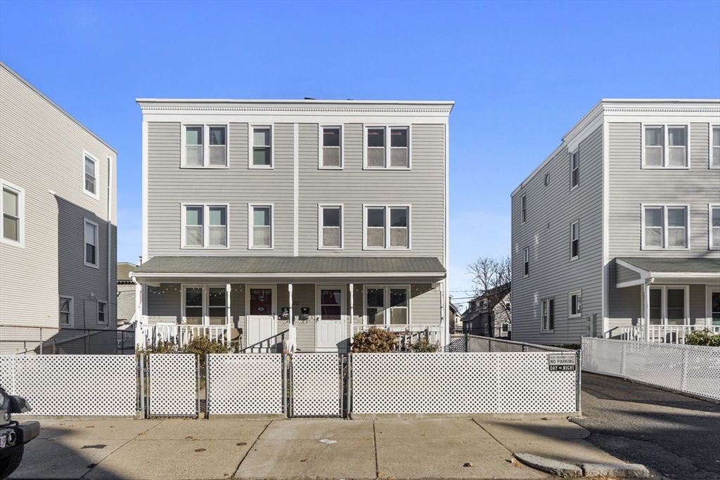 a front view of a building with a yard