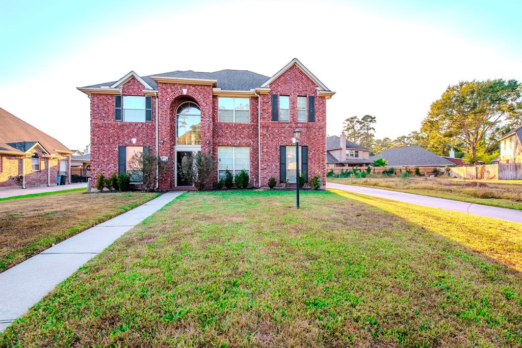 a front view of house with yard and green space