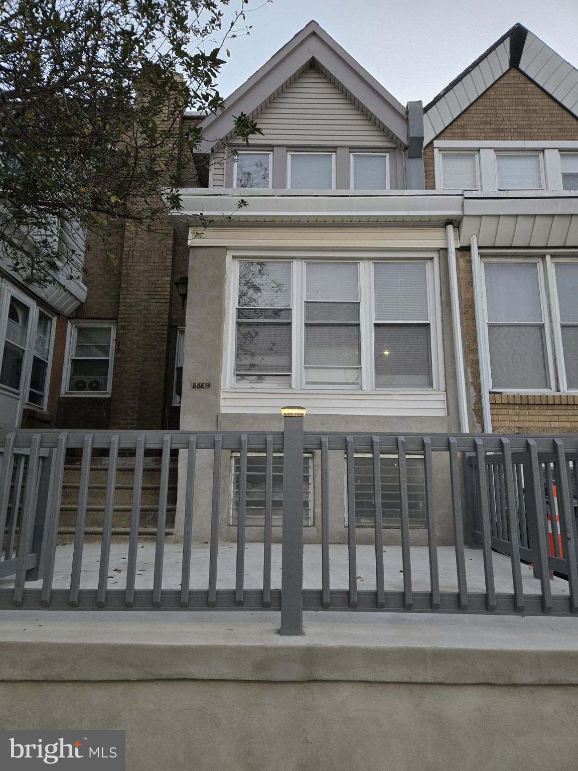 a view of a house with a small yard