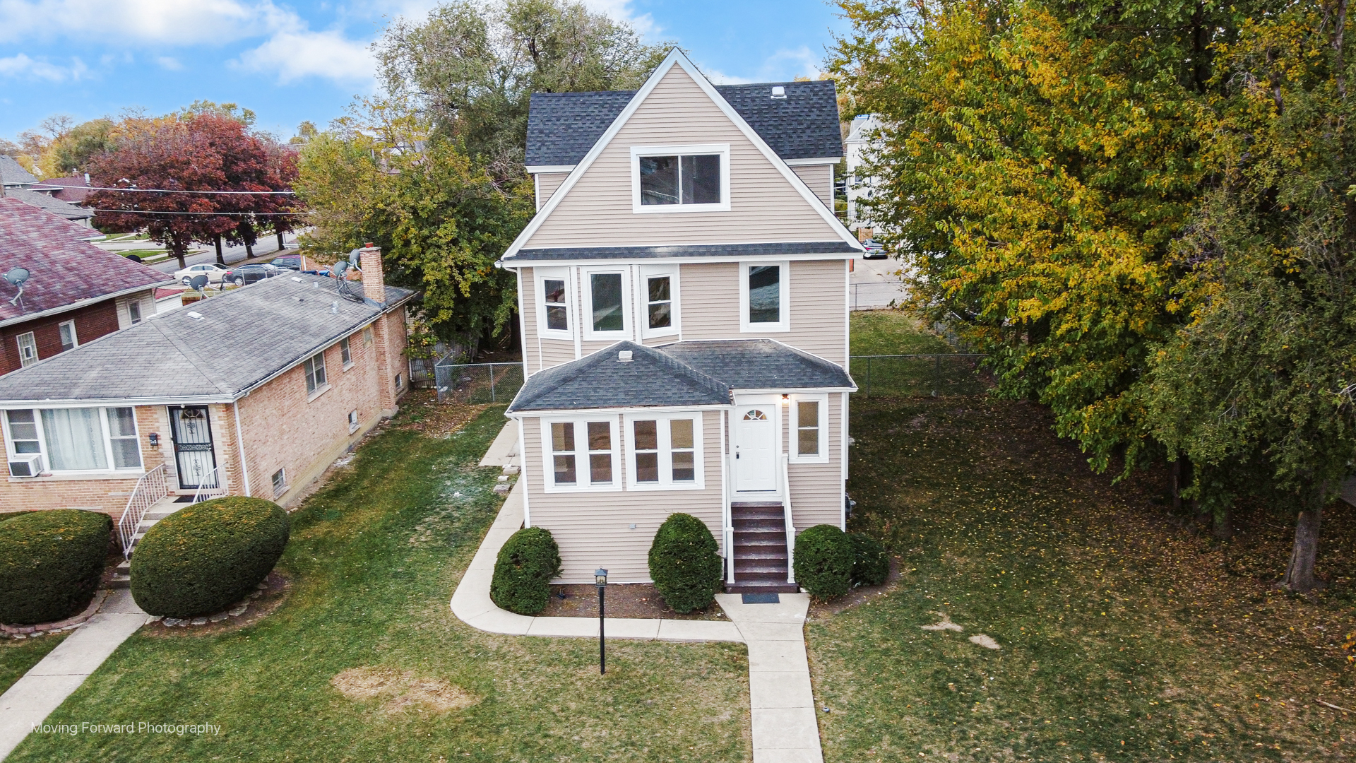 a aerial view of a house next to a yard