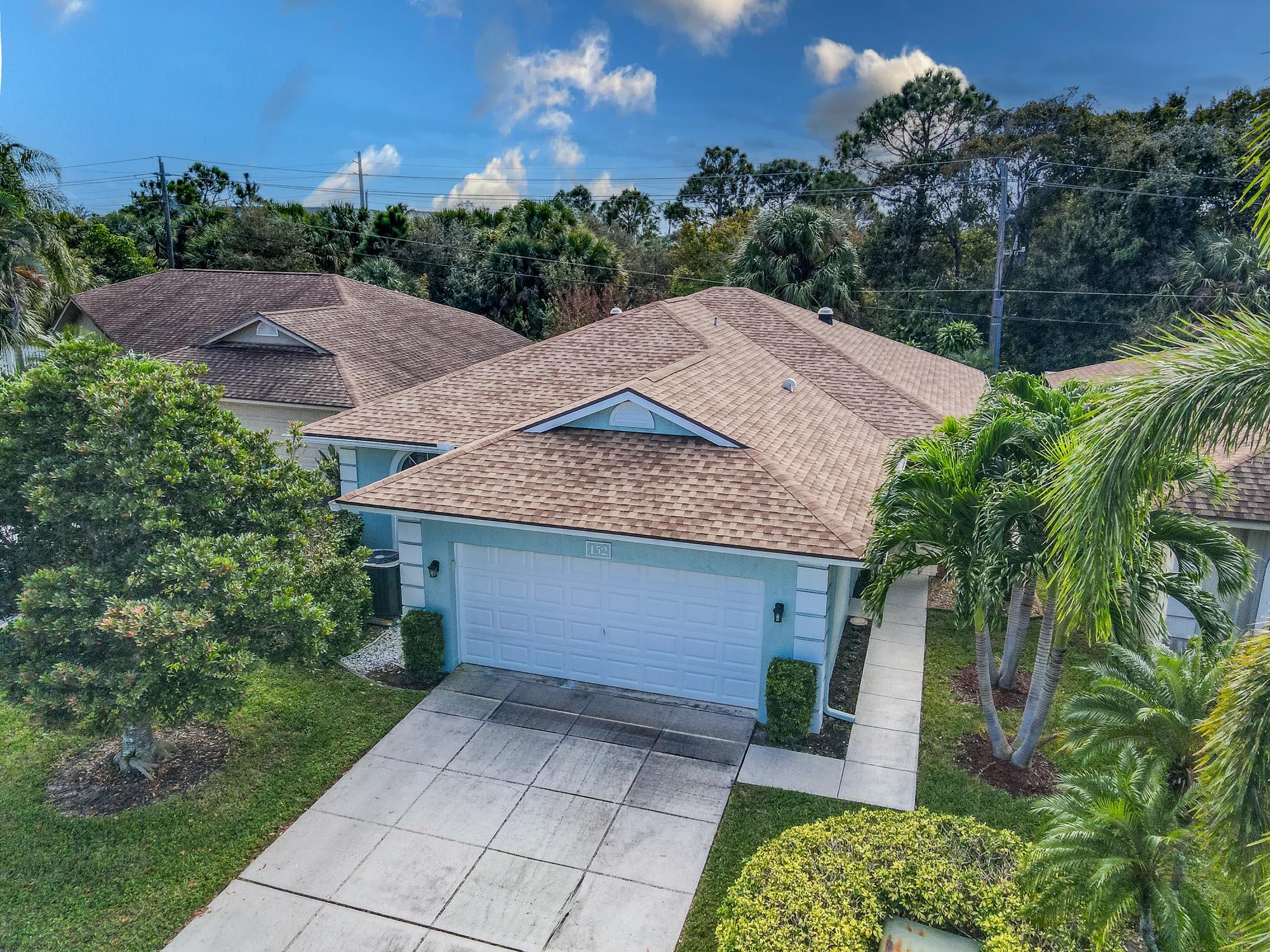 a aerial view of a house with a yard and potted plants