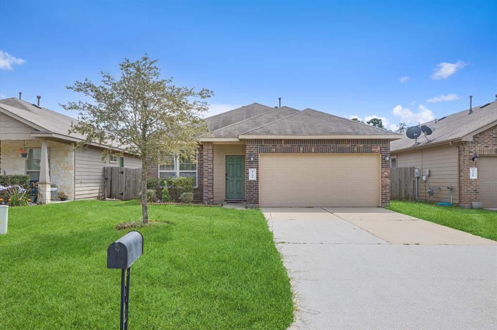 a front view of house with yard and green space