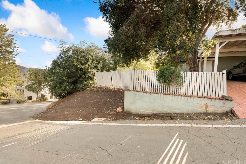 a view of a yard with a street sign