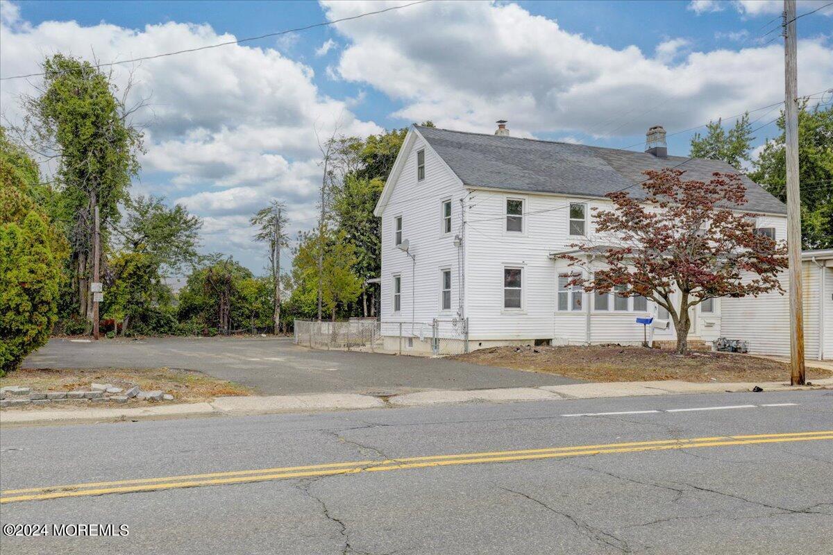 a view of a white house on the side of a street