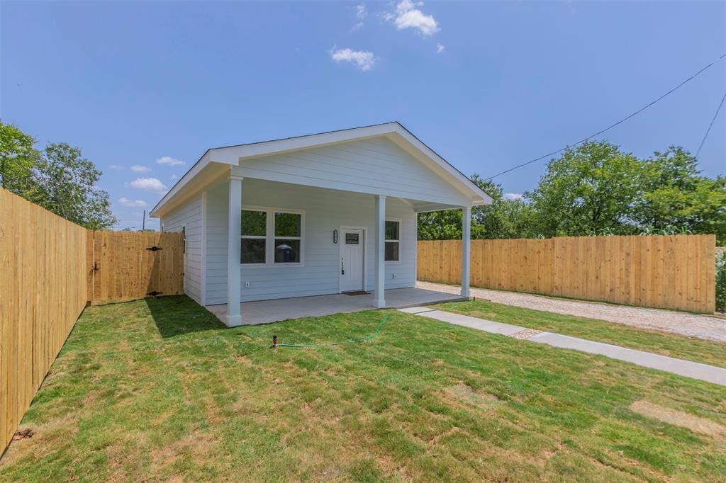 a view of backyard with small cabin