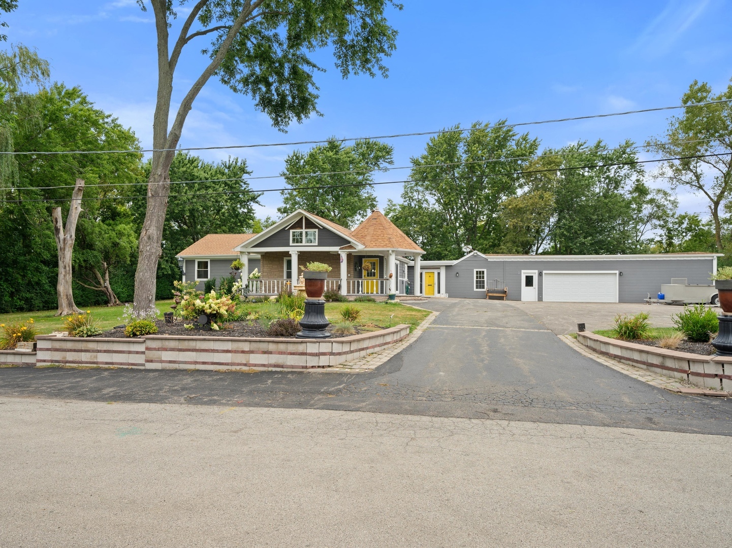 front view of house with a yard and potted plants