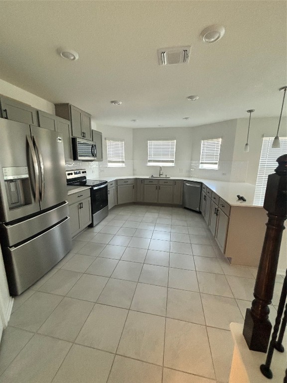 a kitchen with stainless steel appliances a refrigerator sink and cabinets