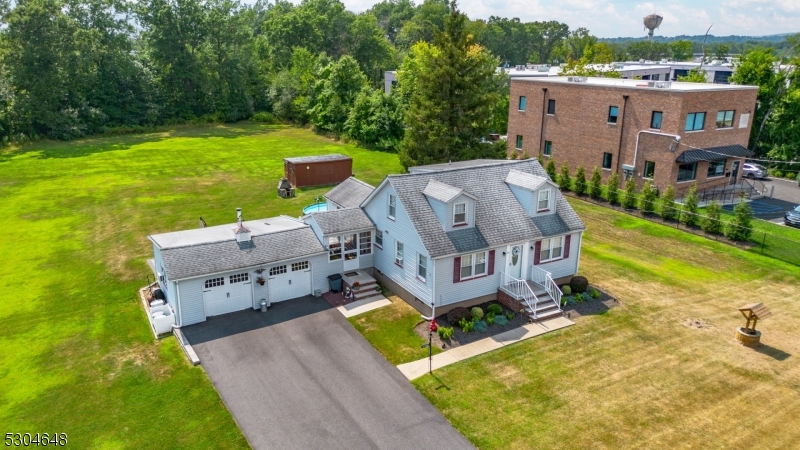 an aerial view of a house with garden space and a patio