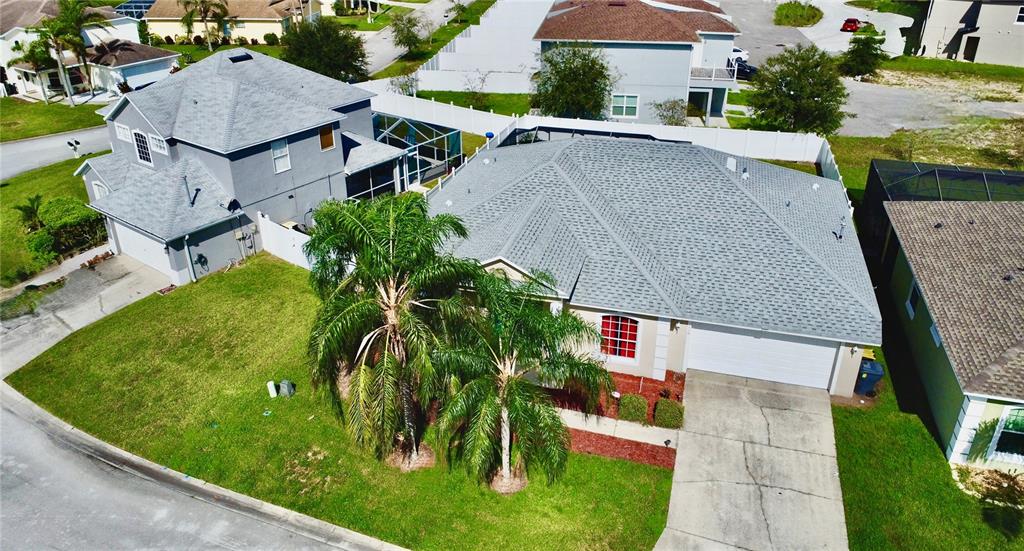 an aerial view of multiple houses with yard