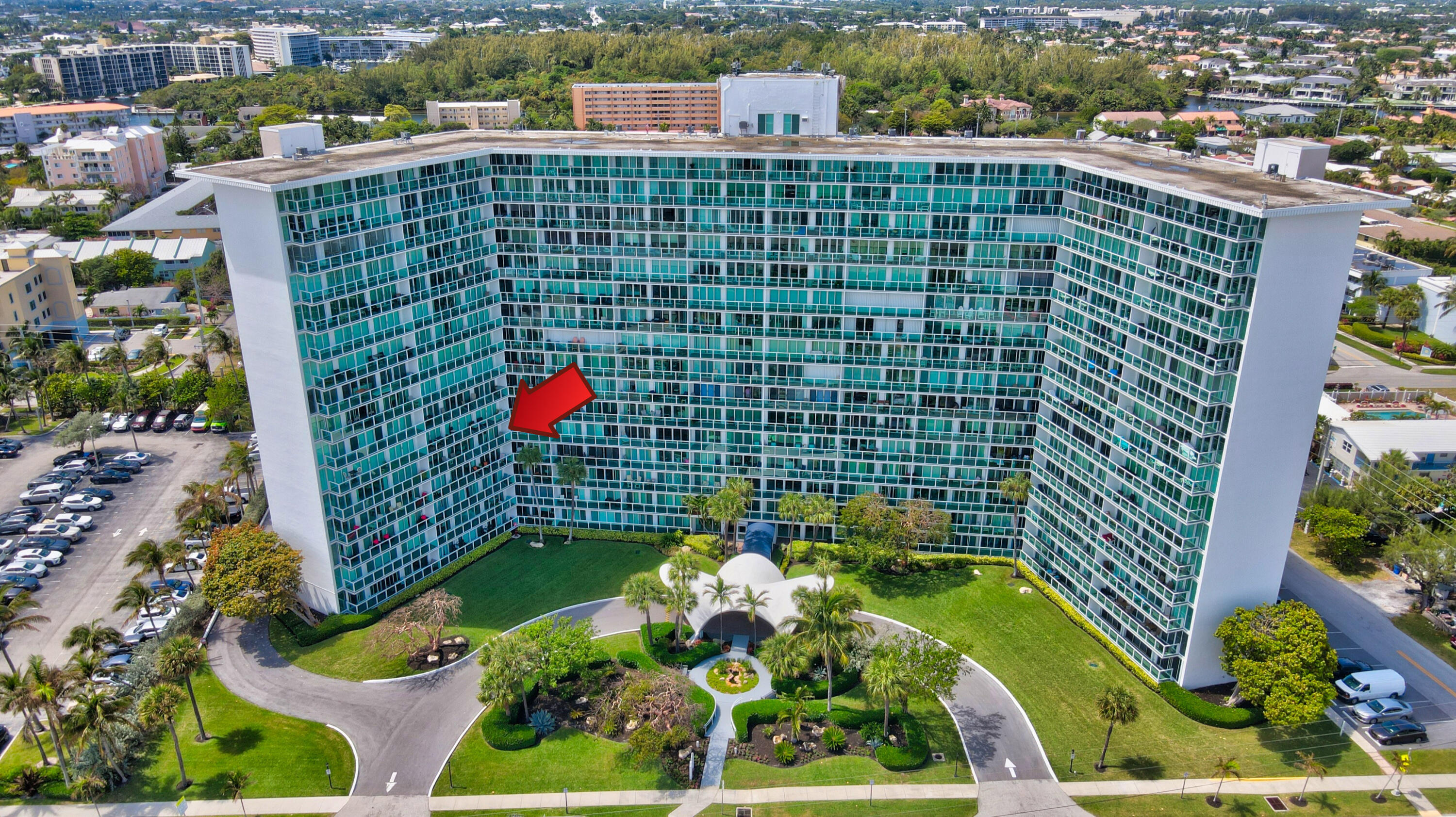 a aerial view of multi story residential apartment building with a yard