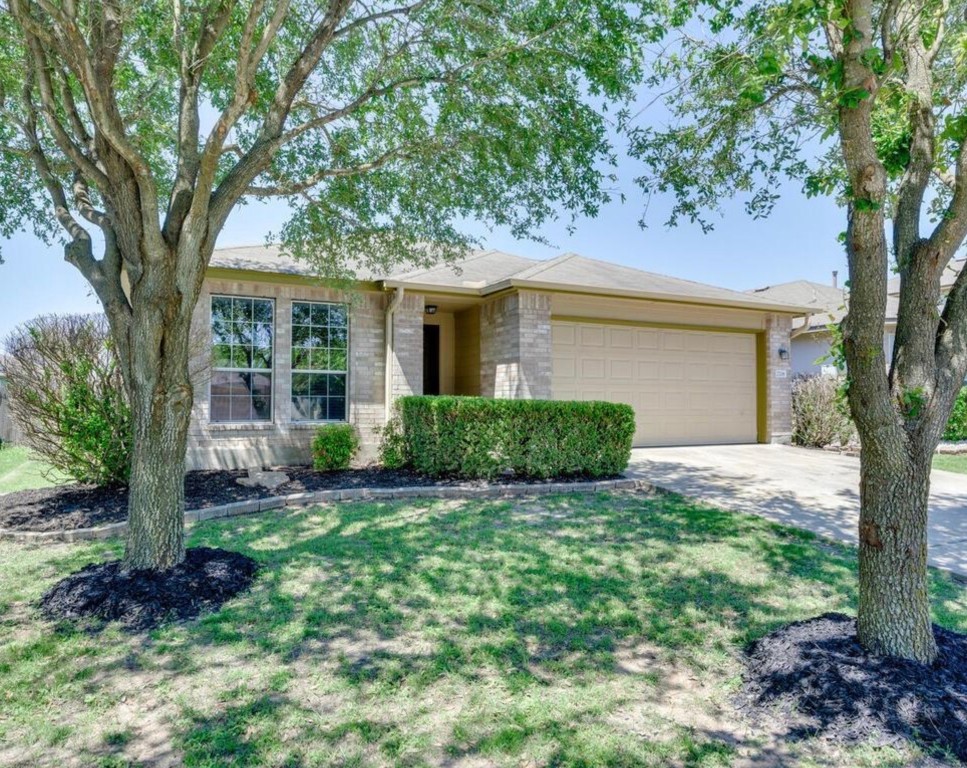 a view of a house with a tree in a yard