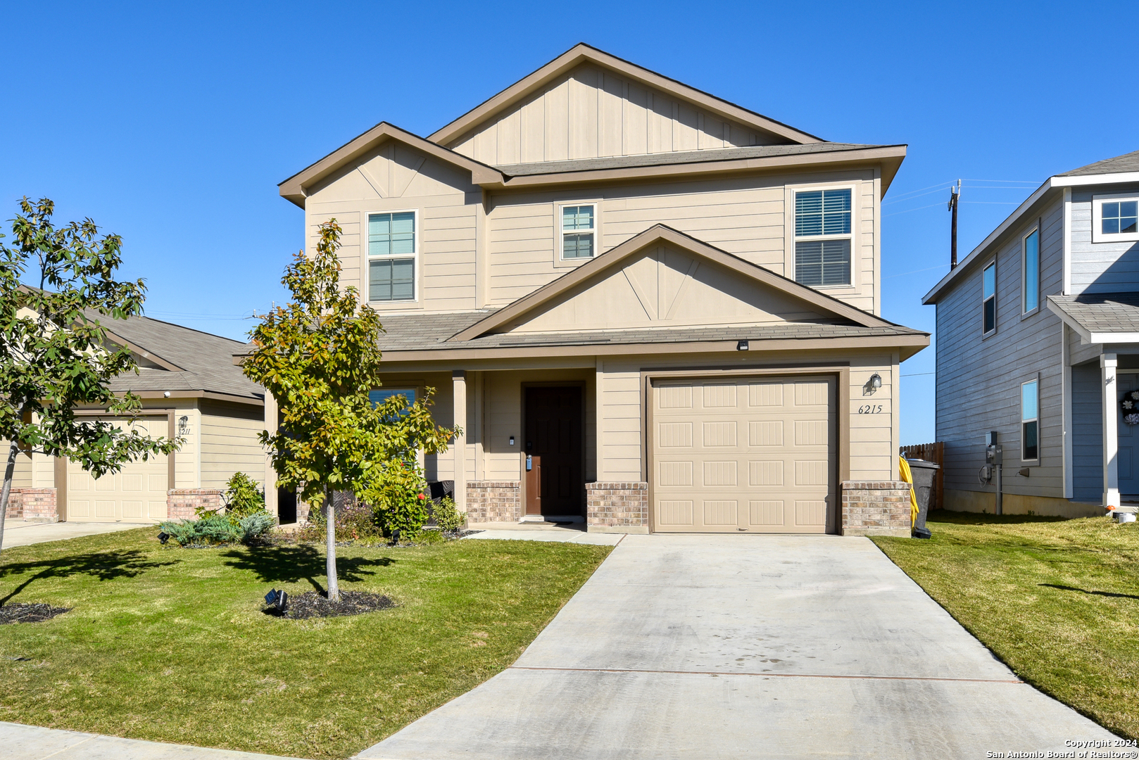 a front view of a house with a yard