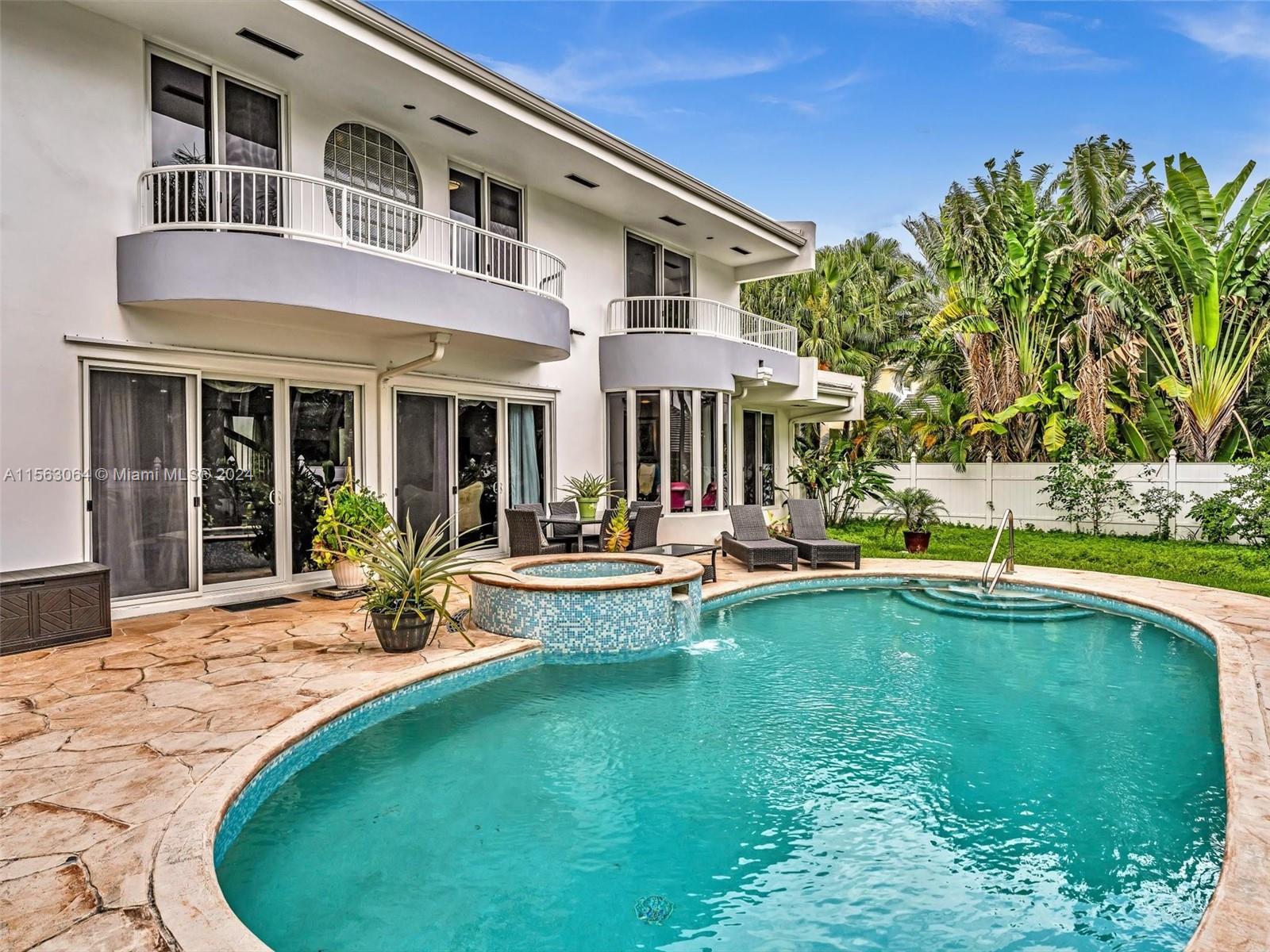 a view of a patio with swimming pool table and chairs